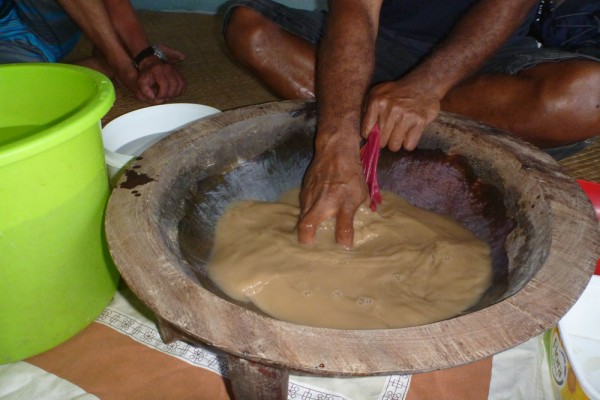 George mixing the yagona powder in the bowl of water and squeezing it to make the kava